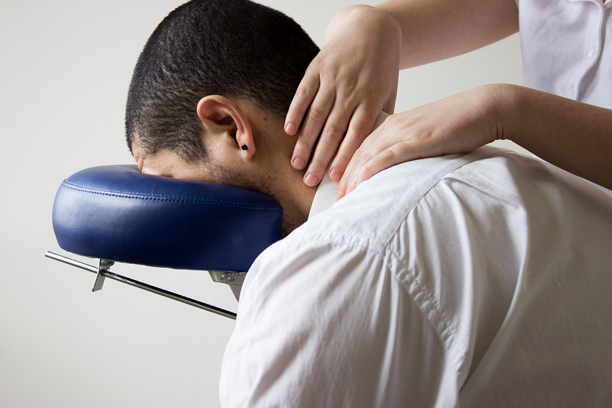 businessman receiving shiatsu on a quick massage chair